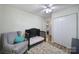Cozy bedroom with a ceiling fan, ample closet space, and a comfortable chair, creating a relaxing personal space at 842 Cherry S Rd, Rock Hill, SC 29732