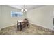 Sunlit dining area with a wooden table and benches, creating a cozy spot for Gathering meals and gatherings at 842 Cherry S Rd, Rock Hill, SC 29732