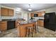 Kitchen features wooden cabinets, granite countertops, and tiled floors at 842 Cherry S Rd, Rock Hill, SC 29732
