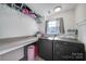 Laundry room with folding table and updated washer and dryer at 842 Cherry S Rd, Rock Hill, SC 29732