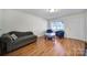 Comfortable living room featuring hardwood floors, cozy seating, and a bright window providing natural light at 842 Cherry S Rd, Rock Hill, SC 29732