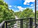 Scenic balcony view featuring lush green trees and a bright blue sky at 871 Academy St, Charlotte, NC 28205