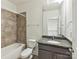 Bathroom featuring vanity with granite counters, with tiled bath and shower at 871 Academy St, Charlotte, NC 28205