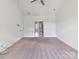 Bright, carpeted bedroom featuring a ceiling fan and a doorway to another room at 871 Academy St, Charlotte, NC 28205