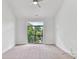 Light-filled bedroom with balcony featuring lush greenery and natural light at 871 Academy St, Charlotte, NC 28205
