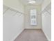 Walk-in closet with built-in shelving and natural light at 871 Academy St, Charlotte, NC 28205