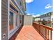 A cozy deck with wood flooring and railing offers outdoor relaxation at 871 Academy St, Charlotte, NC 28205