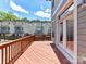 A cozy wooden deck overlooks neighboring townhomes under a blue sky at 871 Academy St, Charlotte, NC 28205