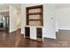 Dining area features hardwood floors and a built-in bar with shelving and mini fridges at 871 Academy St, Charlotte, NC 28205