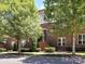 Brick building with lush trees, highlighting the front entrance and well-kept landscaping at 871 Academy St, Charlotte, NC 28205
