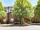 Charming brick building with well-maintained landscaping and mature trees, offering an inviting facade at 871 Academy St, Charlotte, NC 28205