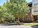 Attractive brick building with mature trees, showing the well-maintained facade and neighborhood feel at 871 Academy St, Charlotte, NC 28205