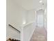Bright hallway with neutral carpet and white walls leading to other rooms at 871 Academy St, Charlotte, NC 28205