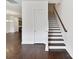 Hallway with a wooden staircase and hardwood floors at 871 Academy St, Charlotte, NC 28205