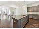 A stylish kitchen area with an island, hardwood floors and open floor plan at 871 Academy St, Charlotte, NC 28205