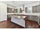 Modern kitchen with stainless appliances, granite countertops, island and hardwood floors at 871 Academy St, Charlotte, NC 28205