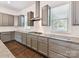 Modern kitchen with gray cabinets, granite countertops, and stainless appliances at 871 Academy St, Charlotte, NC 28205