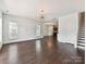 Bright living room with hardwood floors, large windows, and an open layout leading to the kitchen at 871 Academy St, Charlotte, NC 28205