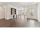 Open living area with hardwood floors and a built-in bar with shelving and mini fridges at 871 Academy St, Charlotte, NC 28205