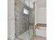 Modern shower with glass door, gray tile, and a soaking tub at 871 Academy St, Charlotte, NC 28205