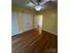 Bedroom featuring hardwood floors, a ceiling fan, and double closets at 8720 Lee St, Mount Pleasant, NC 28124