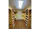 Spacious walk-in closet with custom wooden shelving and ample storage at 8720 Lee St, Mount Pleasant, NC 28124