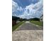 Long driveway leading to a house surrounded by lush greenery at 8720 Lee St, Mount Pleasant, NC 28124