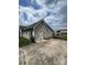Side view of a house with a green door and concrete driveway at 8720 Lee St, Mount Pleasant, NC 28124