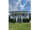 Charming home featuring a welcoming front porch with white railings and meticulously maintained landscaping at 8720 Lee St, Mount Pleasant, NC 28124