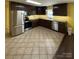 Kitchen featuring stainless appliances, dark cabinets, and tile floors at 8720 Lee St, Mount Pleasant, NC 28124