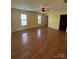 Spacious living room featuring hardwood floors, a ceiling fan, and natural light at 8720 Lee St, Mount Pleasant, NC 28124