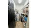Functional utility closet with shelving for storage and water heater at 8720 Lee St, Mount Pleasant, NC 28124