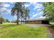 A spacious backyard and exterior of a brick home offer a tranquil setting with a well-maintained lawn at 925 Rock Grove Church Rd, Salisbury, NC 28146