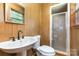 This bathroom features a stall shower, single sink with vanity, and a window at 925 Rock Grove Church Rd, Salisbury, NC 28146