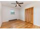 This bedroom features wood floors, white walls, a window, ceiling fan, and a closet at 925 Rock Grove Church Rd, Salisbury, NC 28146