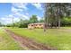 Quaint brick home with lush green lawn, framed by mature trees creates a peaceful residential setting at 925 Rock Grove Church Rd, Salisbury, NC 28146