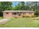 Charming brick home with red shutters and mature trees offers a welcoming front yard at 925 Rock Grove Church Rd, Salisbury, NC 28146