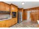 This kitchen features wooden cabinets, stainless steel appliances, and a view into the next room at 925 Rock Grove Church Rd, Salisbury, NC 28146