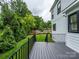 Spacious backyard featuring a dark-gray wooden deck and lush, green landscaping at 9426 Greyson Ridge Dr, Charlotte, NC 28277