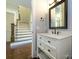 View of a half bath with beautiful staircase that highlights the stylish interior design of the home at 9426 Greyson Ridge Dr, Charlotte, NC 28277