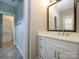 Elegant bathroom vanity with white cabinets, a marble countertop, and modern fixtures at 9426 Greyson Ridge Dr, Charlotte, NC 28277