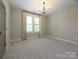 Bedroom with carpet, a window, and neutral decor, providing a serene and comfortable atmosphere at 9426 Greyson Ridge Dr, Charlotte, NC 28277