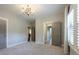 Spacious bedroom with carpet, large window, and multiple doors, offering versatility and comfort at 9426 Greyson Ridge Dr, Charlotte, NC 28277