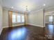 Spacious dining room showcases stunning wood floors, modern light fixture, and bright, neutral paint at 9426 Greyson Ridge Dr, Charlotte, NC 28277