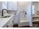 This lovely dog wash area features a white marble surround with black fixtures, sink, and cabinetry at 9426 Greyson Ridge Dr, Charlotte, NC 28277