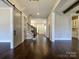 A spacious foyer with hardwood floors, stairs, an open concept, and a sliding barn door at 9426 Greyson Ridge Dr, Charlotte, NC 28277