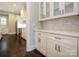 A butler's pantry with white cabinets, marble backsplash, and stainless steel appliances at 9426 Greyson Ridge Dr, Charlotte, NC 28277