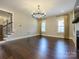 Bright living room features hardwood floors, a modern chandelier, and lots of space at 9426 Greyson Ridge Dr, Charlotte, NC 28277