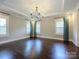 A bright and airy main bedroom featuring large windows, neutral walls, and hardwood floors at 9426 Greyson Ridge Dr, Charlotte, NC 28277