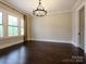 A bright room with hardwood floors, a chandelier, and natural light at 9426 Greyson Ridge Dr, Charlotte, NC 28277